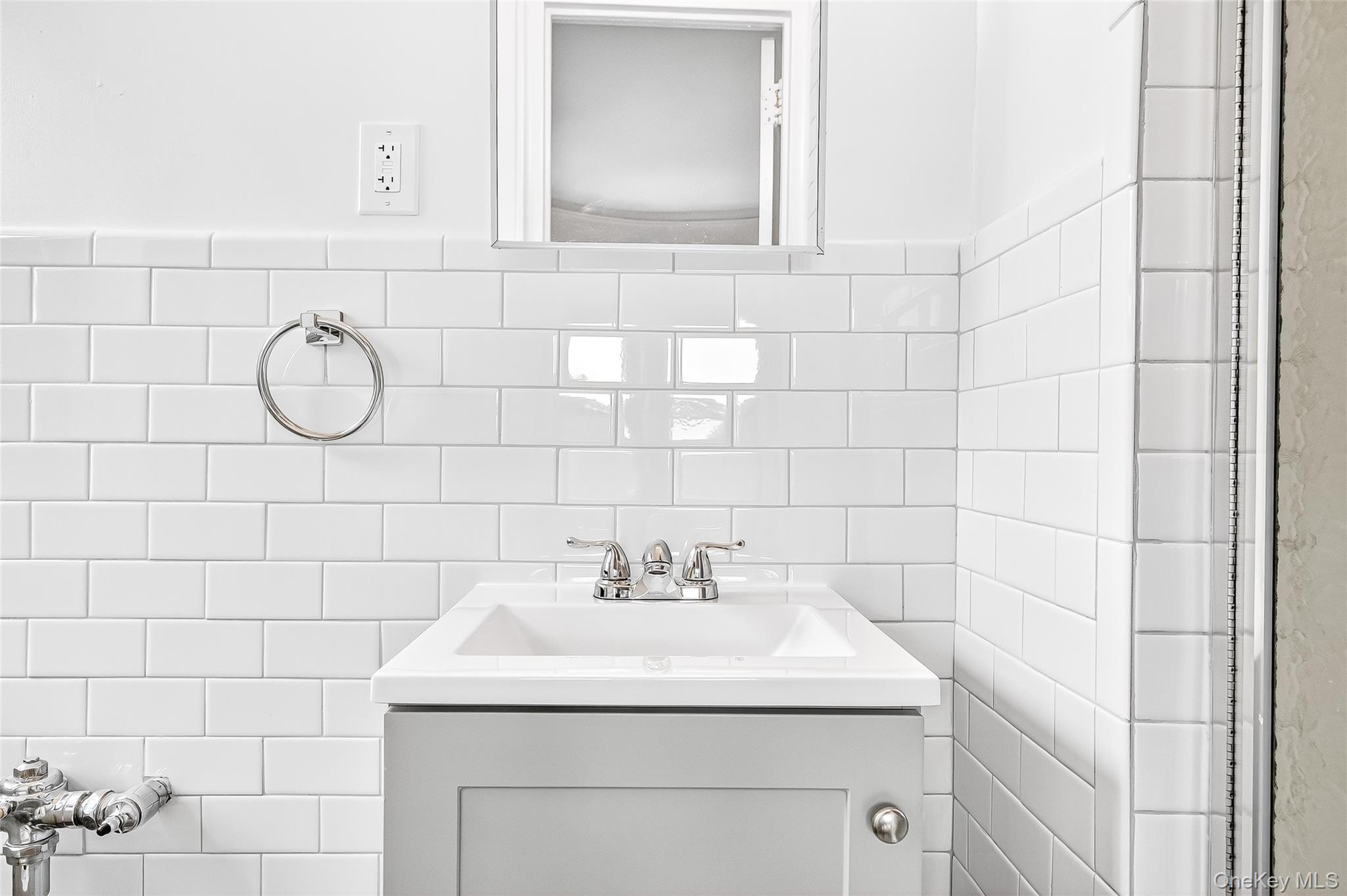 190 East Mosholu Parkway South, Unit 3C Bronx, NY 10458 - Photo 38 of 50 Full bath featuring tile walls, vanity, and tasteful backsplash