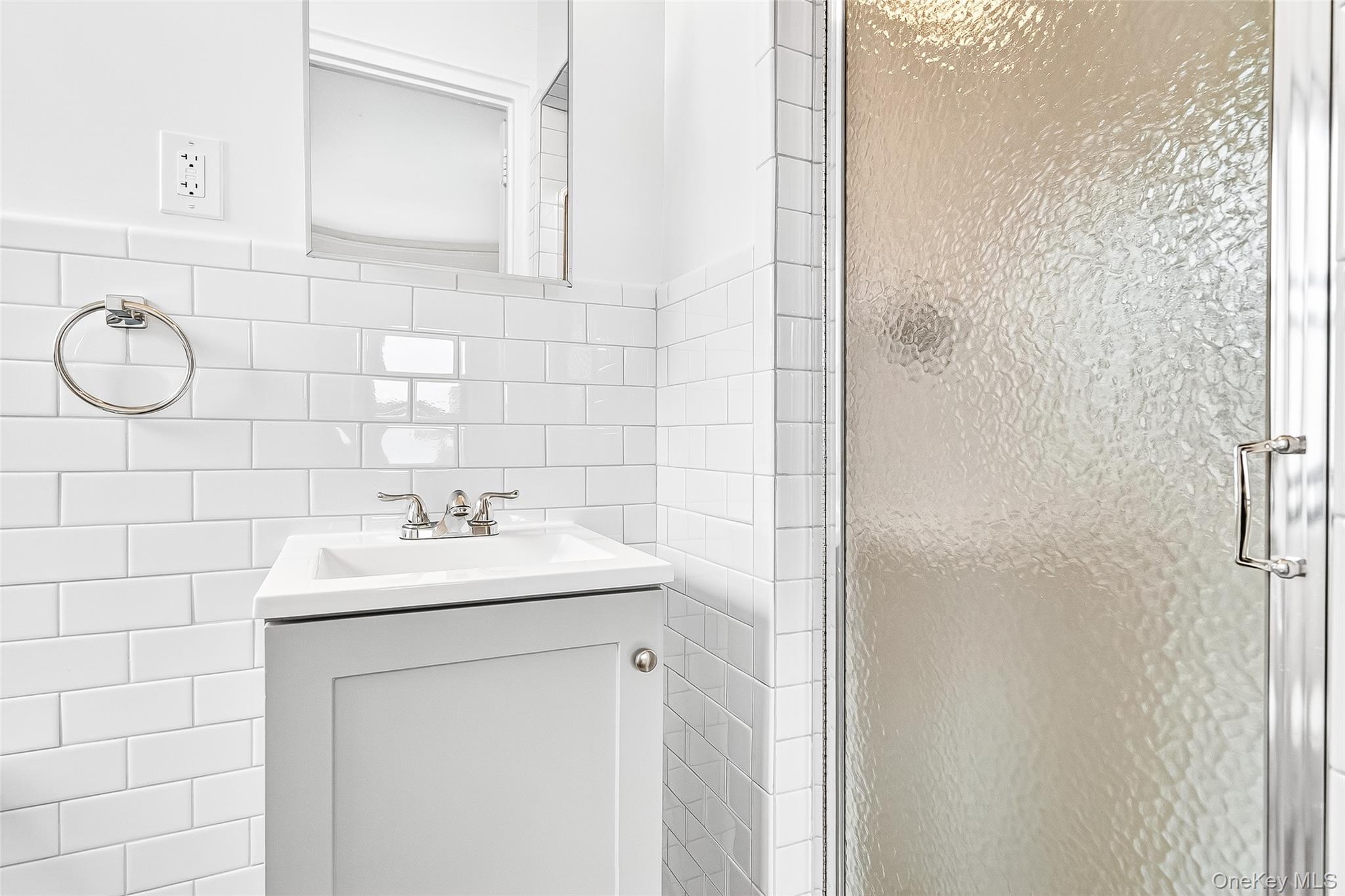 190 East Mosholu Parkway South, Unit 3C Bronx, NY 10458 - Photo 39 of 50 Bathroom featuring vanity, a stall shower, and tile walls