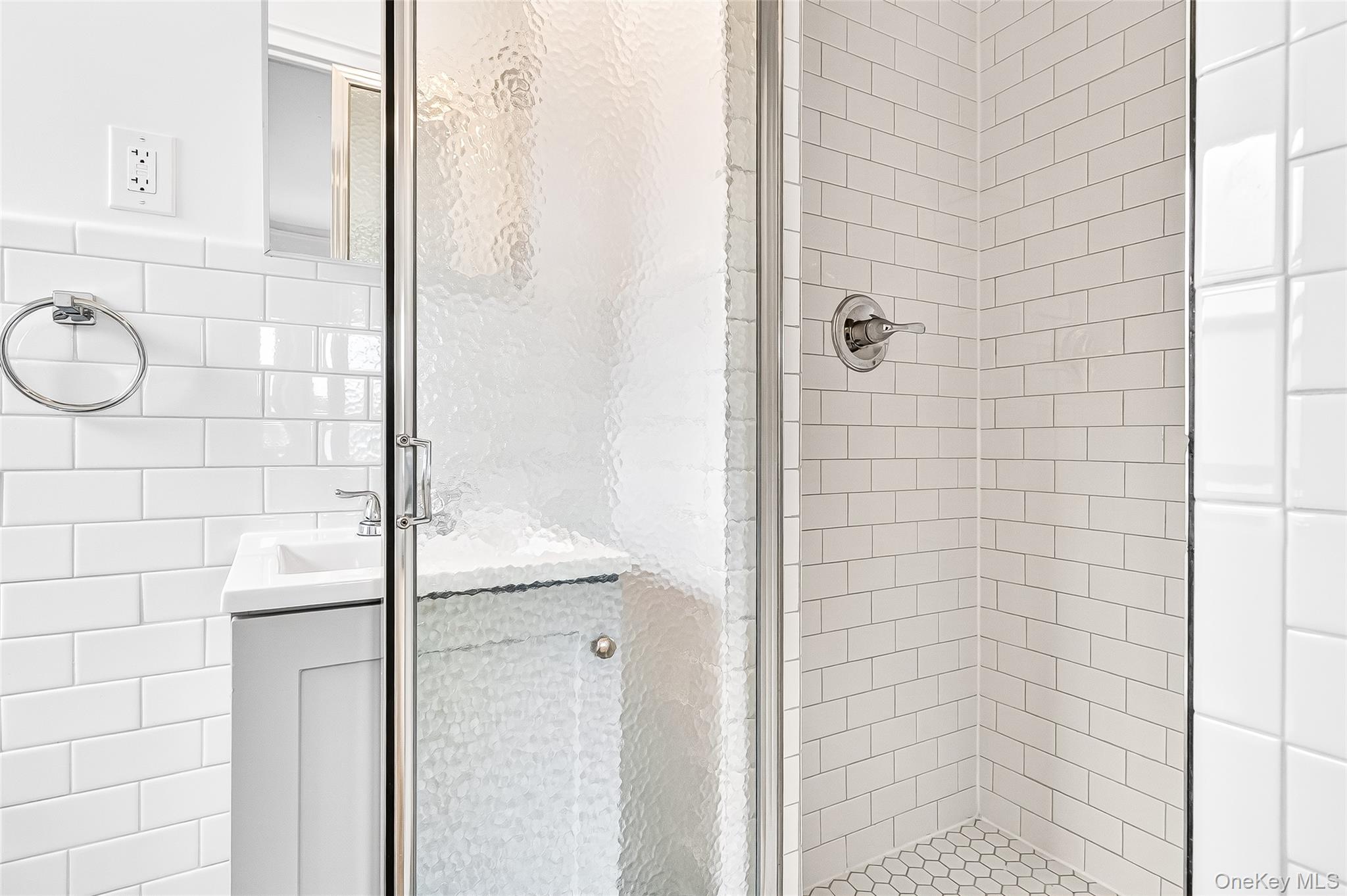 190 East Mosholu Parkway South, Unit 3C Bronx, NY 10458 - Photo 40 of 50 Bathroom with a stall shower, tile walls, and vanity