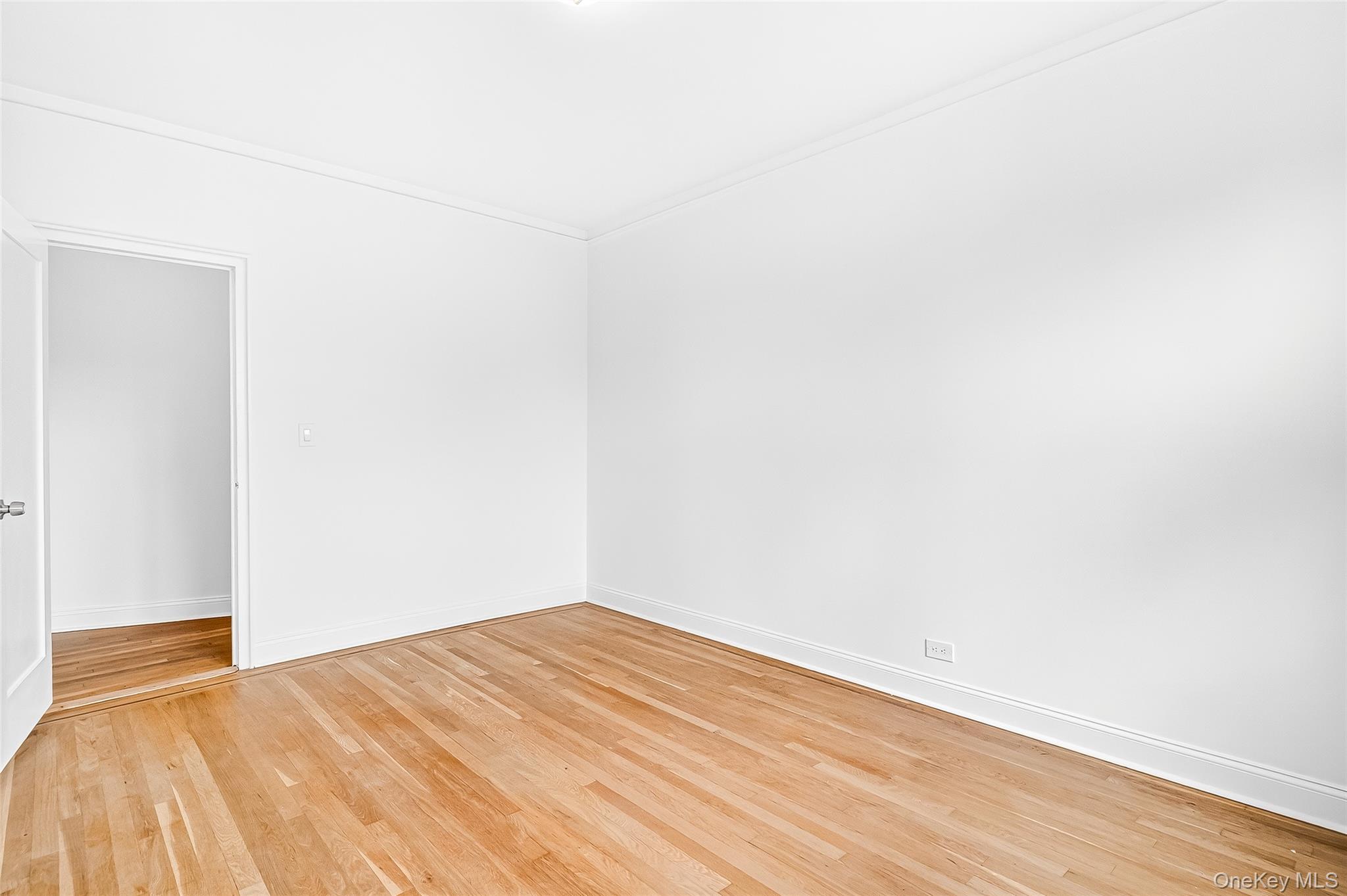 190 East Mosholu Parkway South, Unit 3C Bronx, NY 10458 - Photo 44 of 50 Unfurnished room with light wood finished floors and baseboards