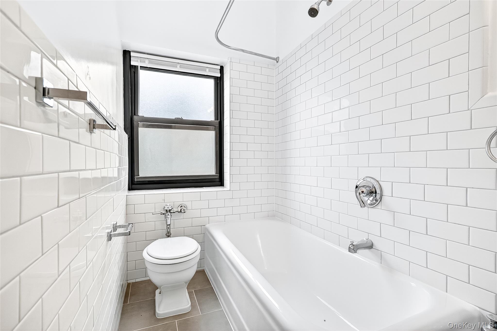 190 East Mosholu Parkway South, Unit 3C Bronx, NY 10458 - Photo 46 of 50 Full bath featuring shower combination, tile walls, and tile patterned flooring