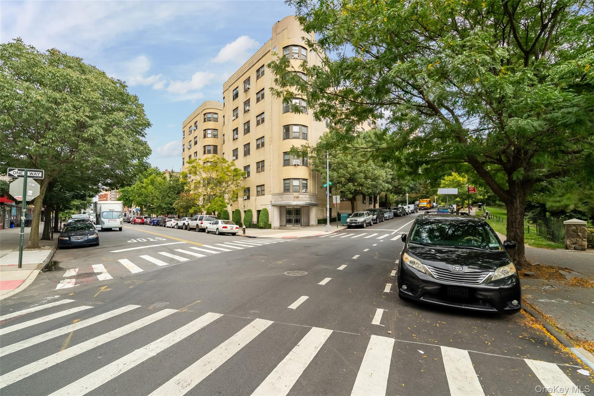 190 East Mosholu Parkway South, Unit 3C Bronx, NY 10458 - Photo 49 of 50 View of asphalt street featuring curbs, street lights, sidewalks, and traffic signs