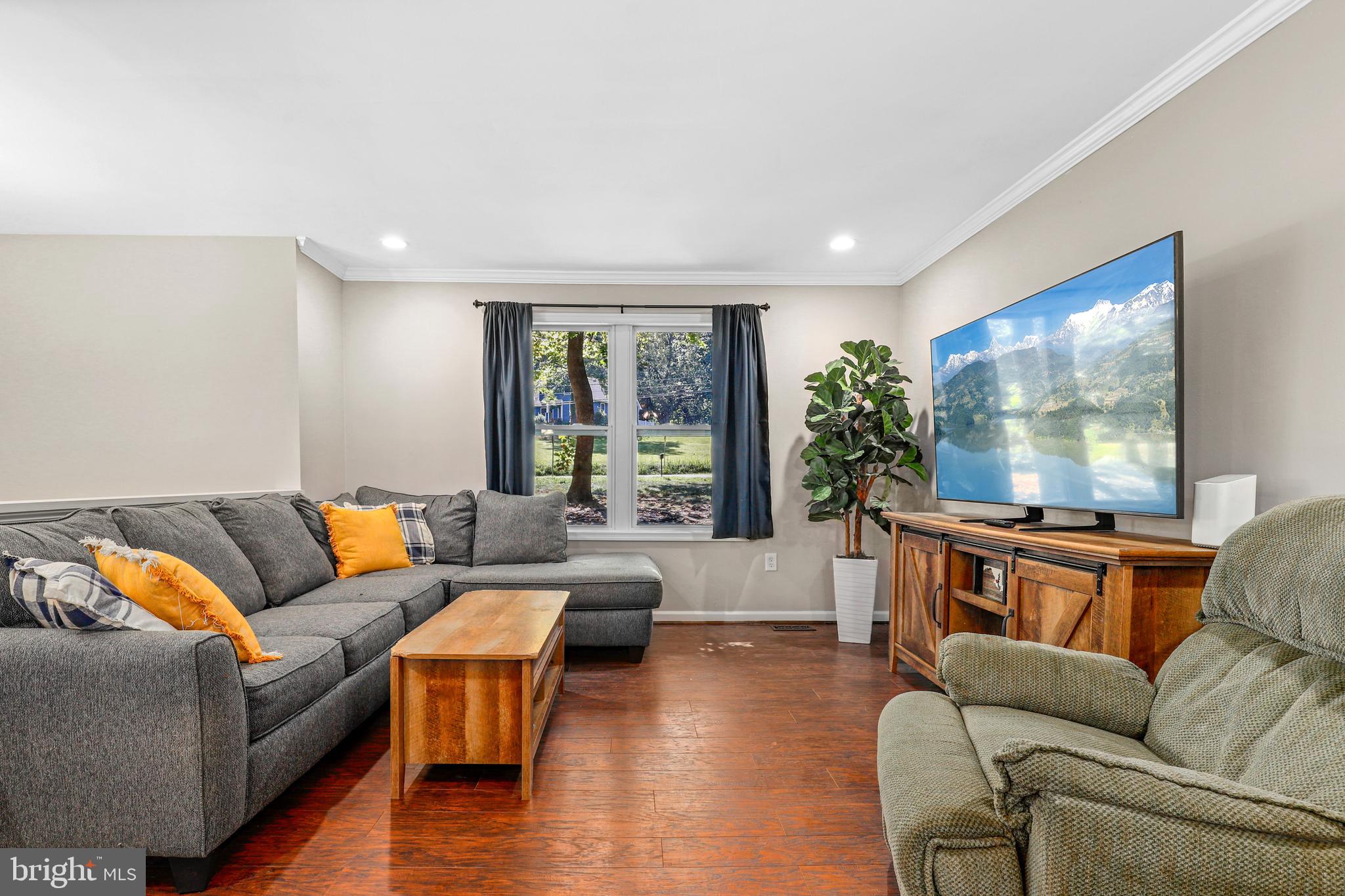956 Wilson Road Huntingtown, MD 20639 - Photo 14 of 42 a living room with furniture and a flat screen tv
