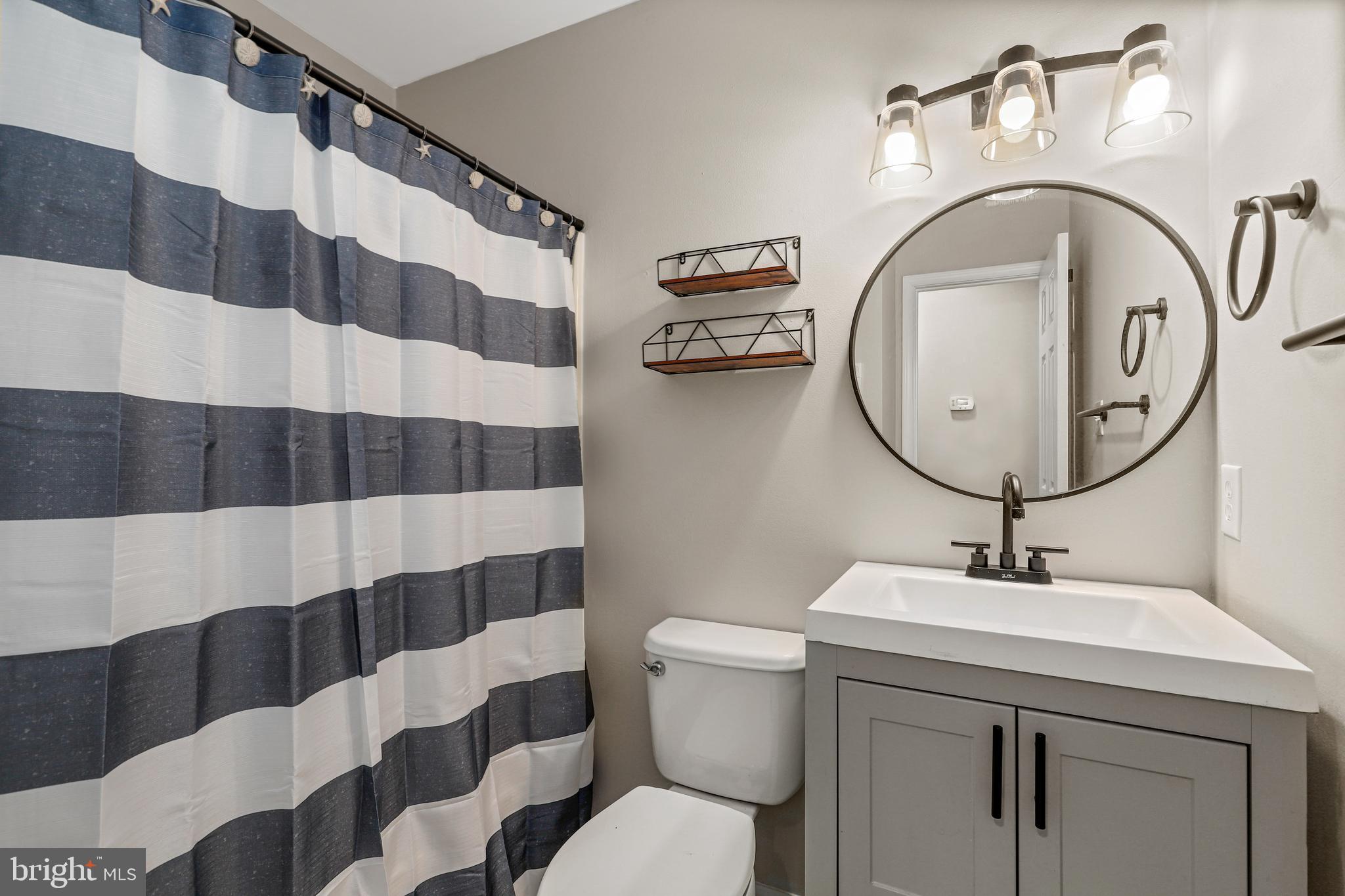 956 Wilson Road Huntingtown, MD 20639 - Photo 19 of 42 a bathroom with a sink a toilet and a mirror