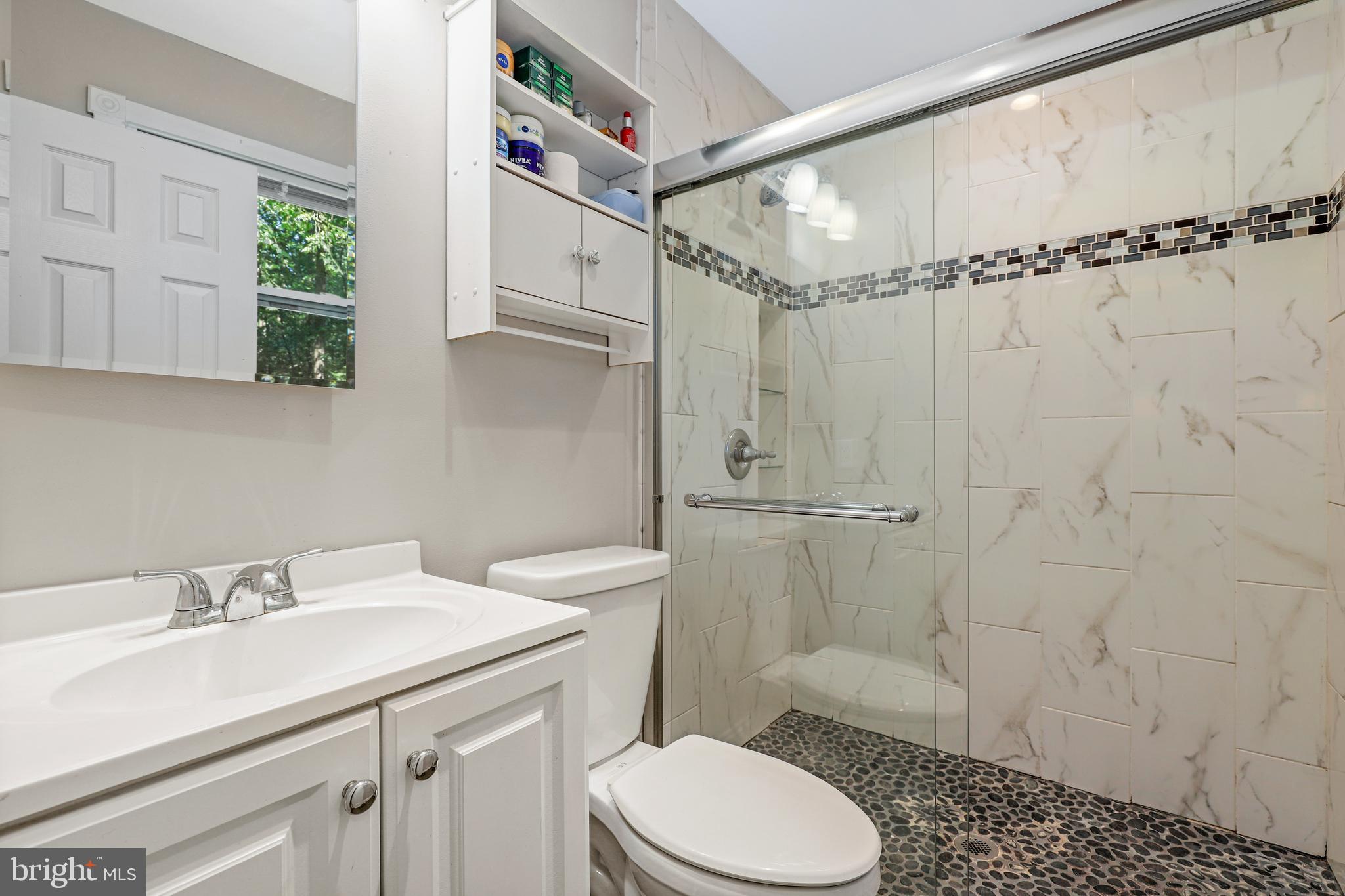 956 Wilson Road Huntingtown, MD 20639 - Photo 21 of 42 a bathroom with a sink toilet and shower