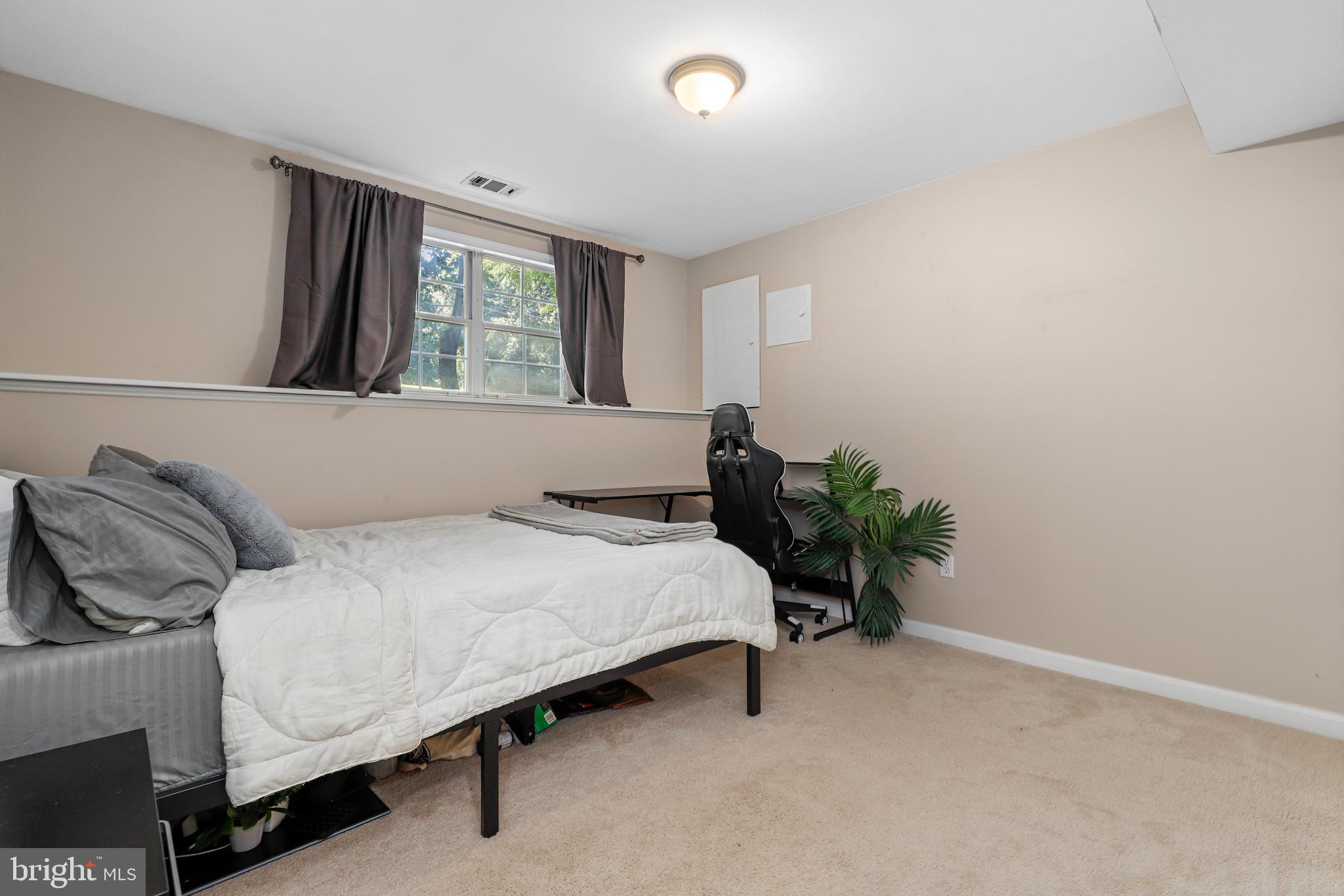 956 Wilson Road Huntingtown, MD 20639 - Photo 27 of 42 a bedroom with a bed and window