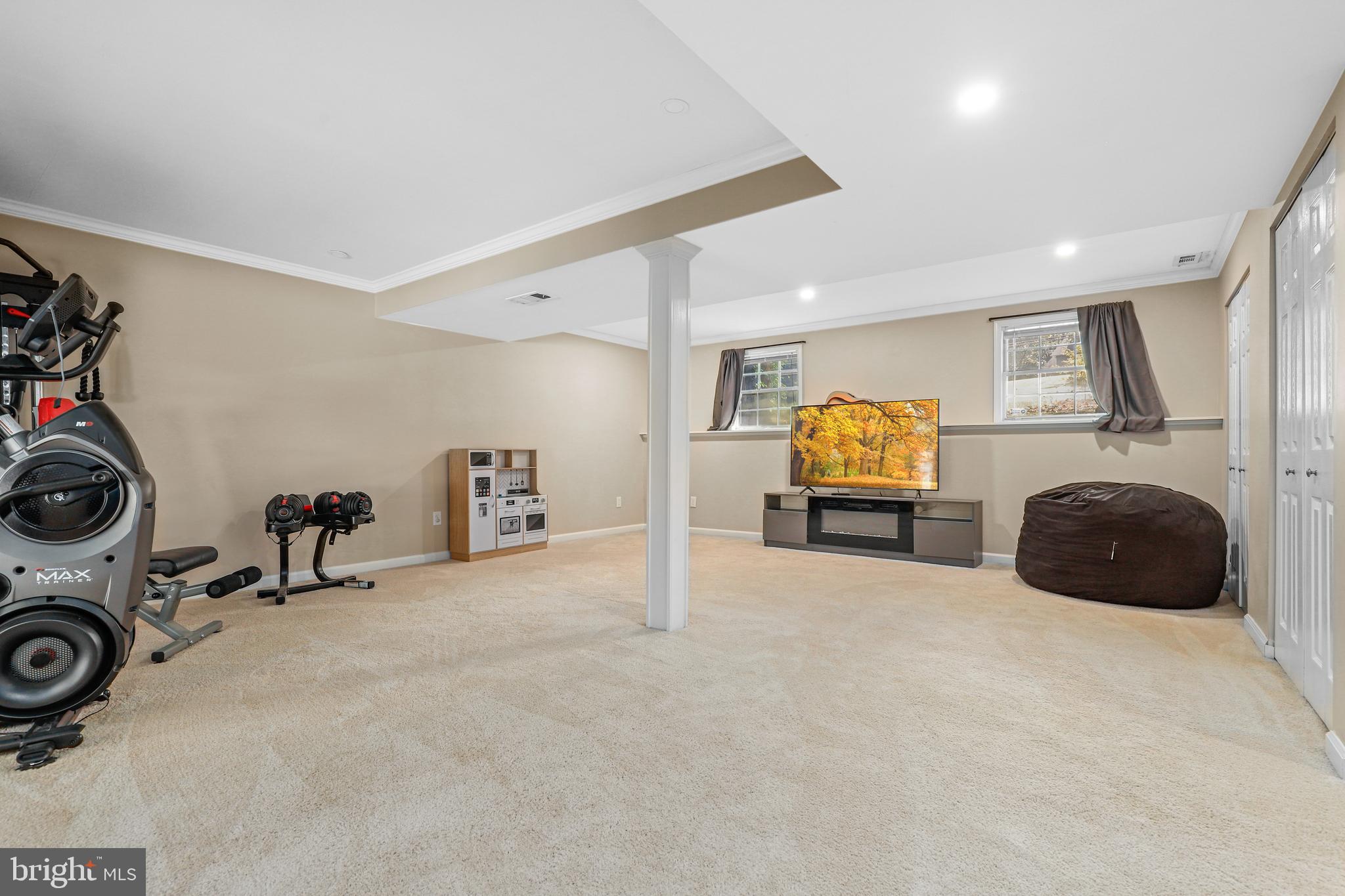 956 Wilson Road Huntingtown, MD 20639 - Photo 33 of 42 a room with a bed a couch and dresser