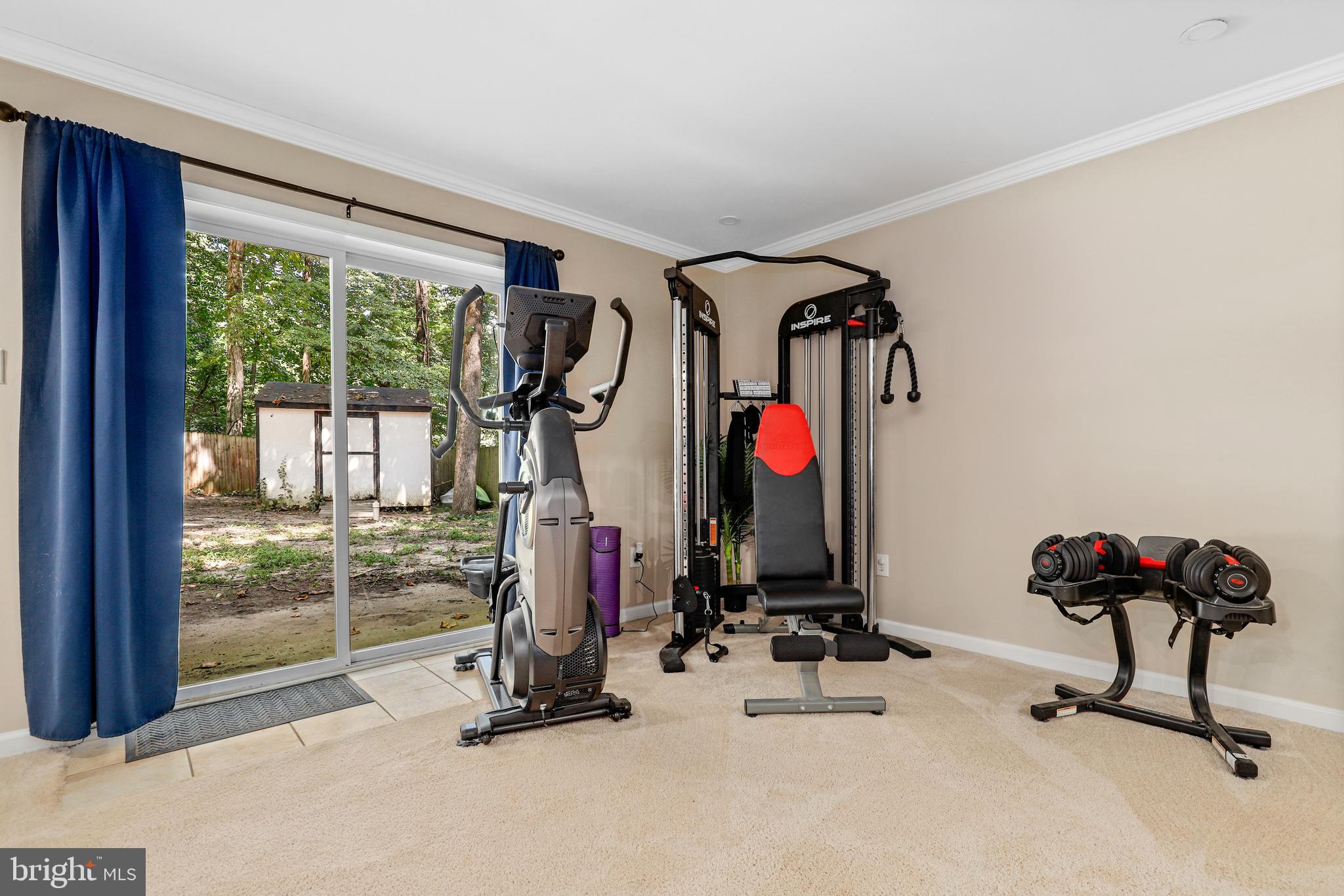 956 Wilson Road Huntingtown, MD 20639 - Photo 34 of 42 a view of a room with gym equipment and floor to ceiling window