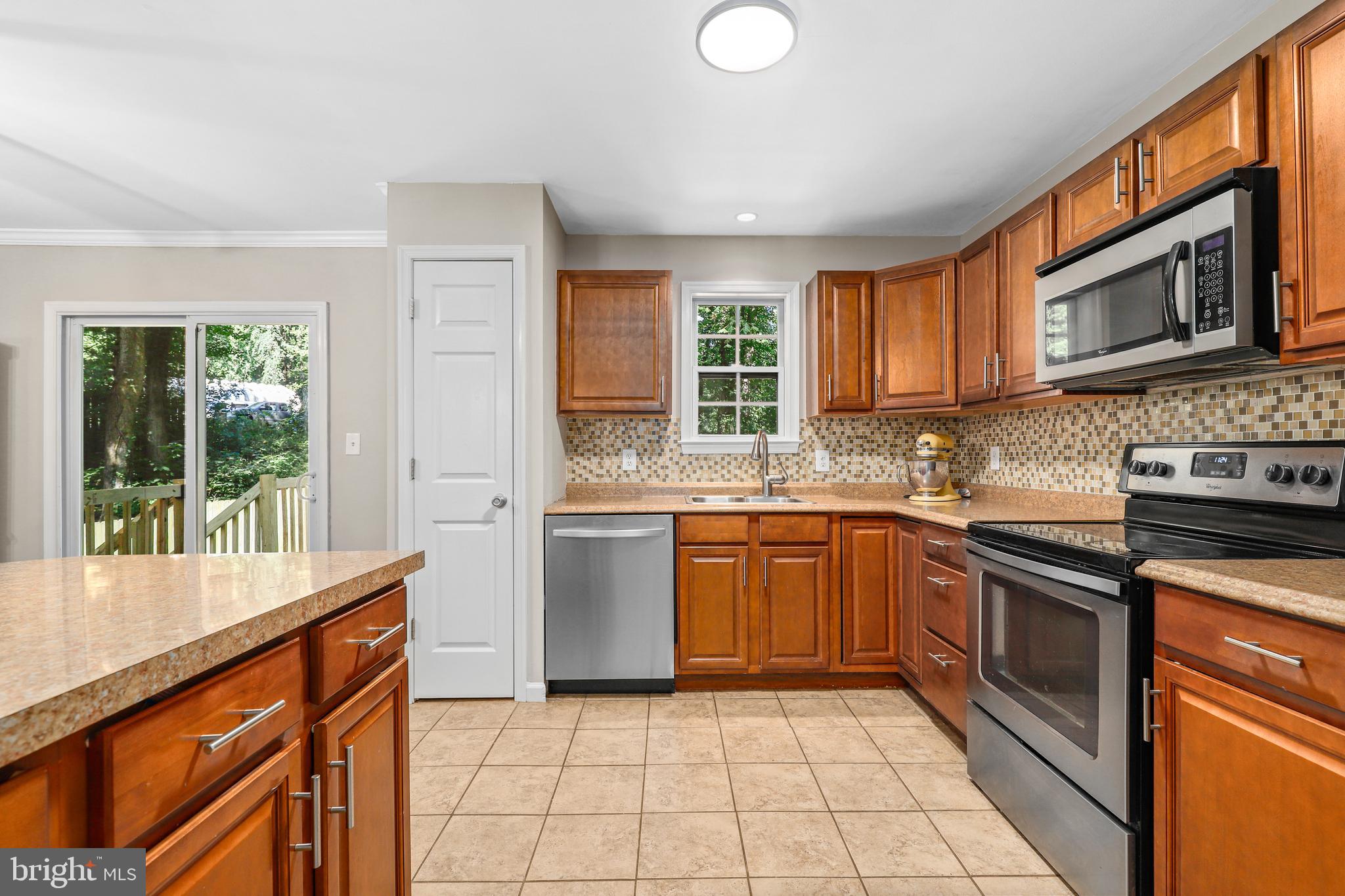 956 Wilson Road Huntingtown, MD 20639 - Photo 5 of 42 a kitchen with stainless steel appliances granite countertop a stove sink and cabinets