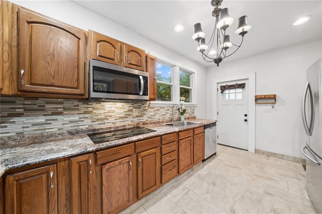 1523 Evergreen Road Pittsburgh, PA 15209 - Photo 11 of 35 a kitchen with stainless steel appliances granite countertop a sink and cabinets