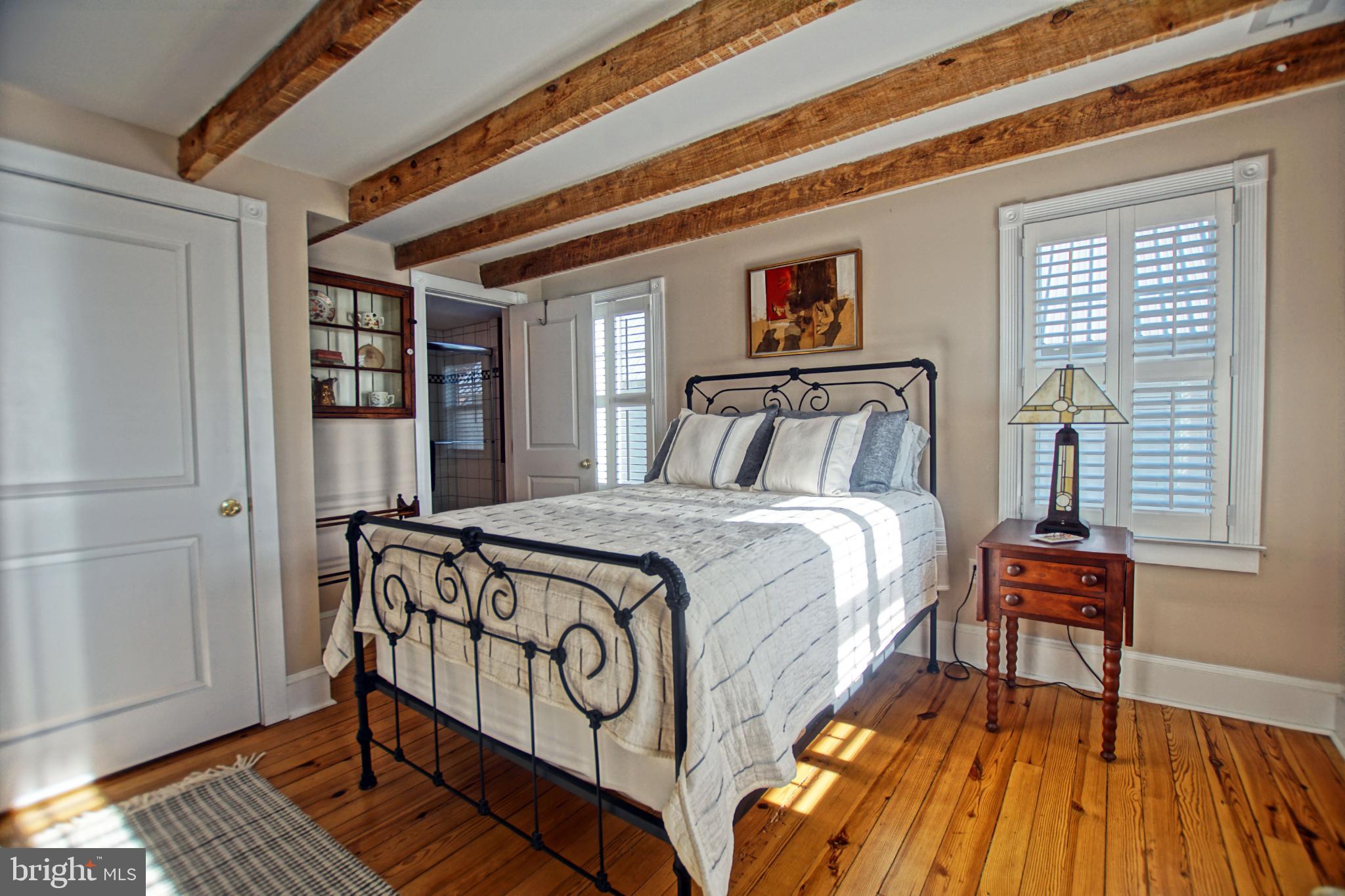 119 Dewey Avenue Lewes, DE 19958 - Photo 25 of 54 Charming bedroom with rustic wooden beams.