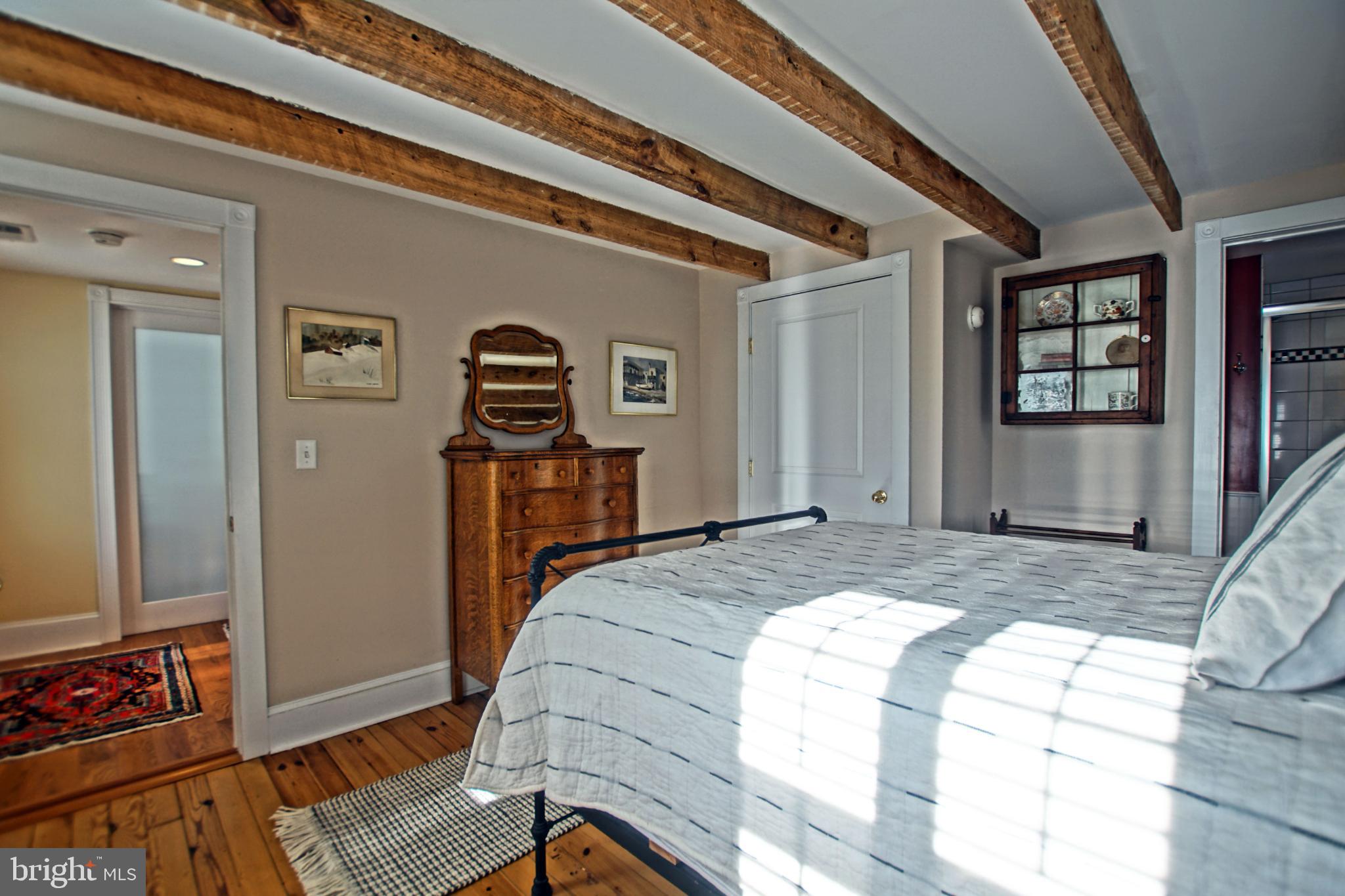 119 Dewey Avenue Lewes, DE 19958 - Photo 26 of 54 Charming bedroom with rustic wooden beams.