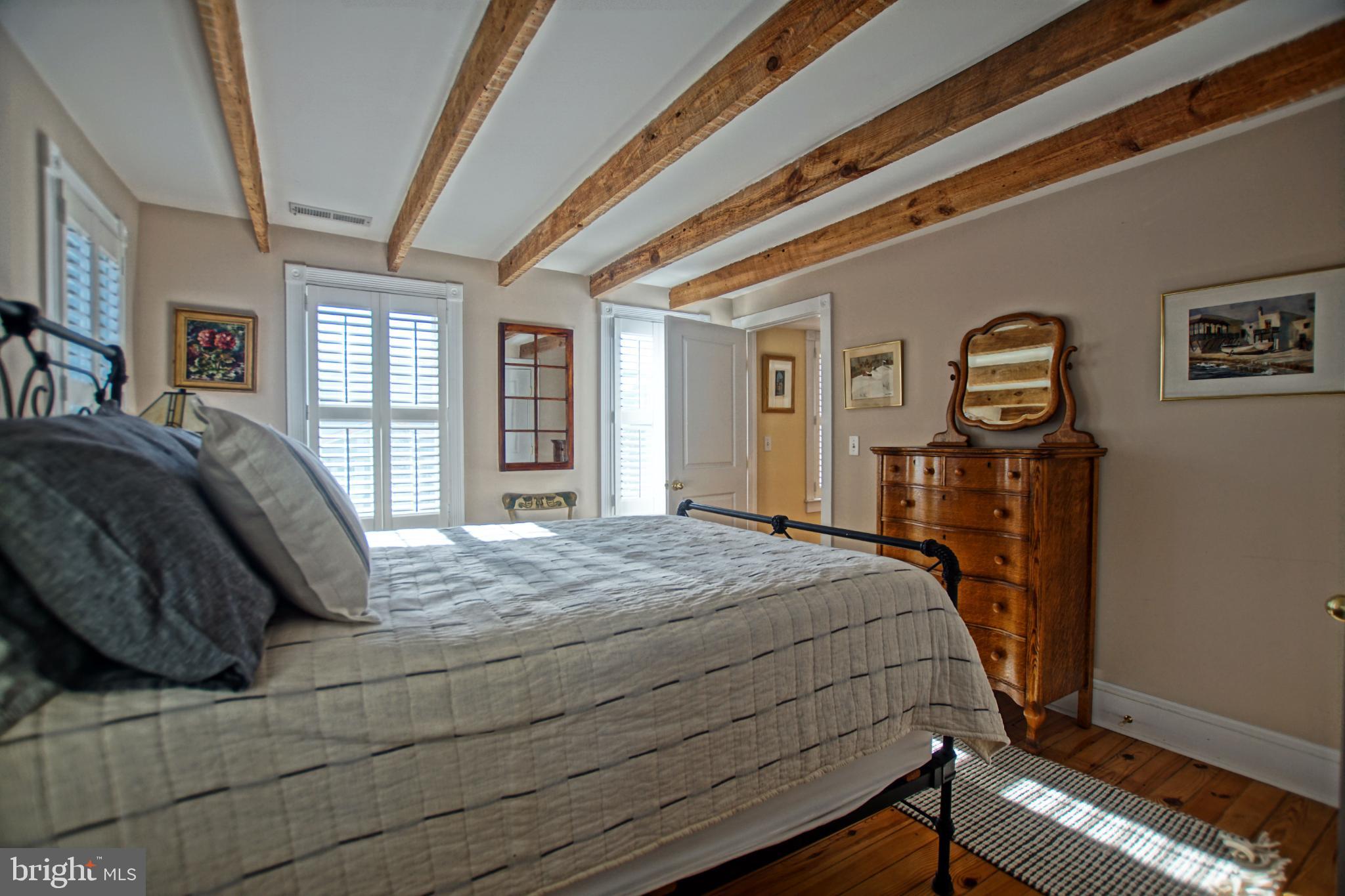 119 Dewey Avenue Lewes, DE 19958 - Photo 28 of 54 Charming bedroom with rustic wooden beams.