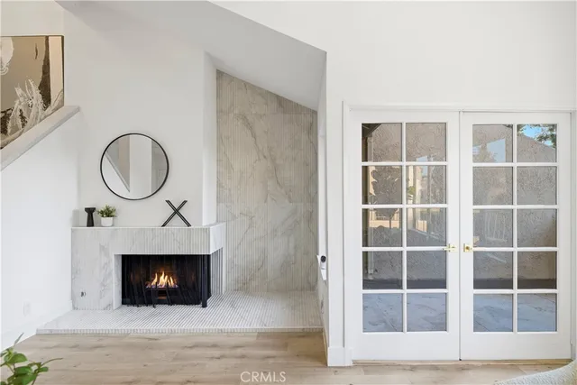 a living room with a fireplace and a rug