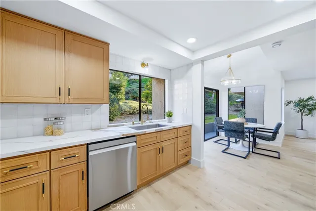 a kitchen with sink cabinets and dining table chair