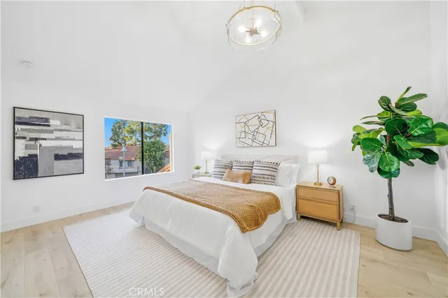 a bedroom with a bed and a potted plant