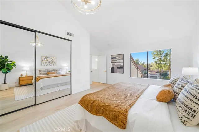 a bedroom with a bed and a painting on the wall