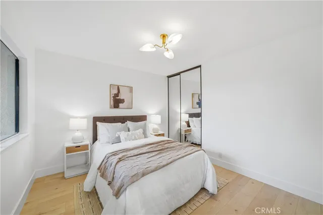 a bedroom with a bed and a chandelier