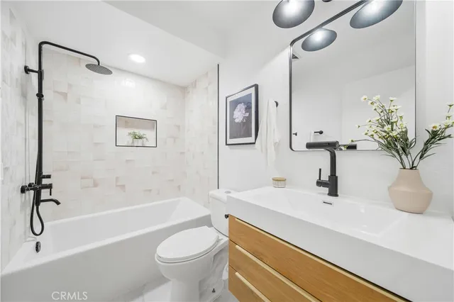 a bathroom with a sink a toilet and a bathtub