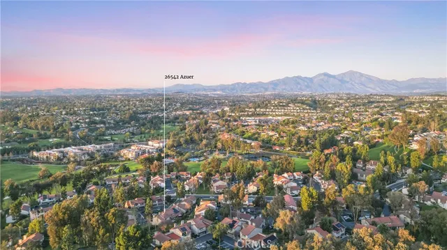 an aerial view of residential house with outdoor space and trees