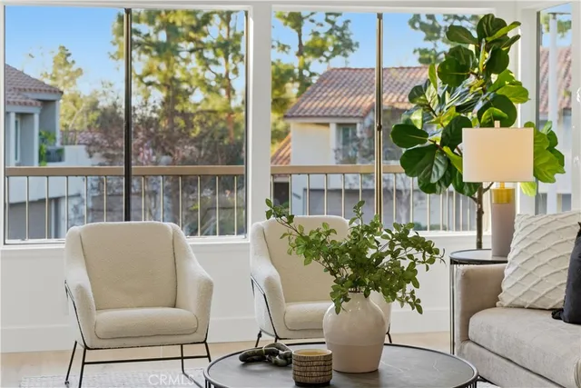 a living room with furniture and a potted plant