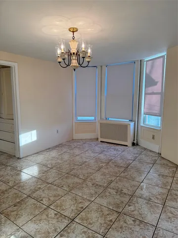 a view of an empty room with a chandelier