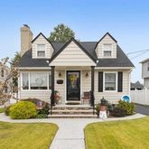 a view of a house with swimming pool and sitting area