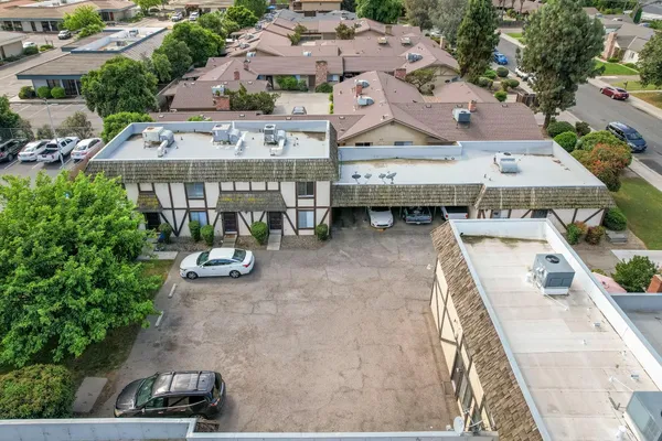 an aerial view of a house with swimming pool and chairs