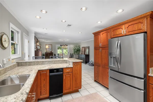 a kitchen with stainless steel appliances granite countertop a refrigerator and a stove