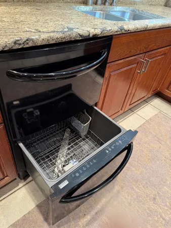 a kitchen with stainless steel appliances granite countertop a sink and cabinets