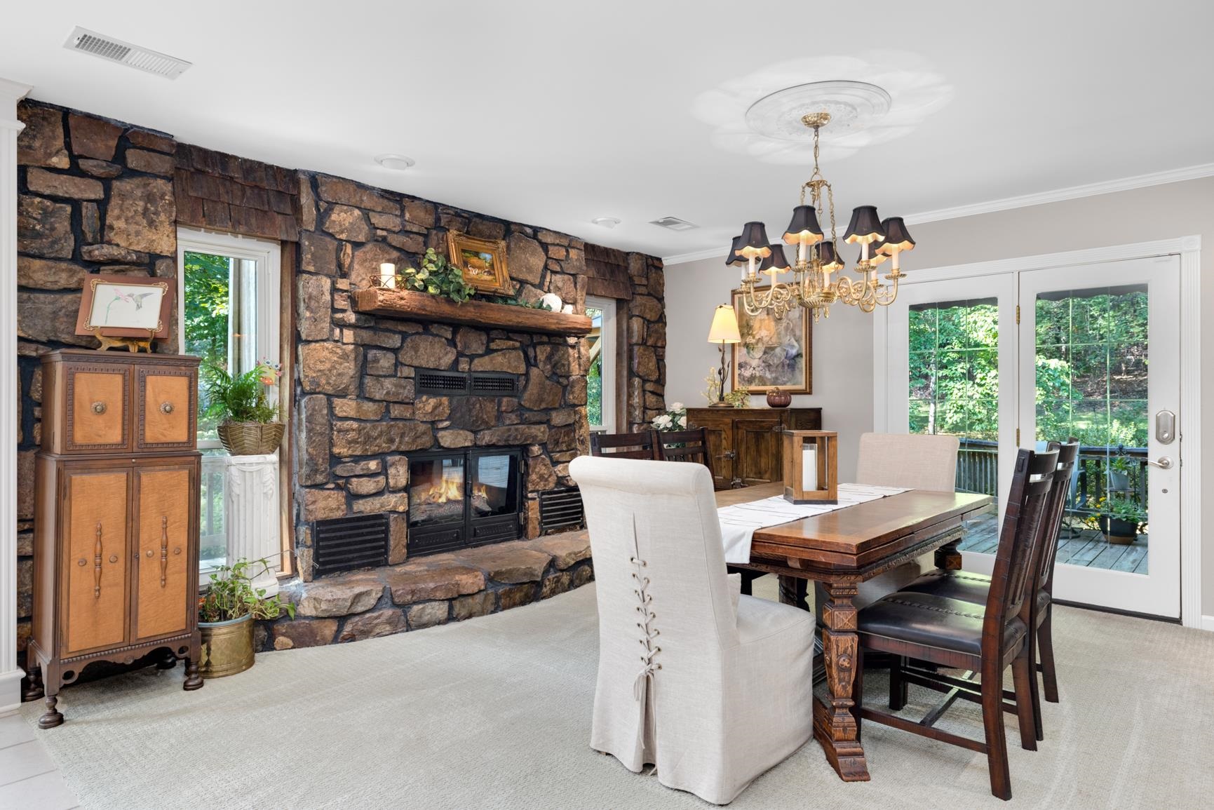 120 Blueberry Road Eads, TN 38028 - Photo 22 of 35 You'll love having this large Dining Room with wall to wall Arkansas Stone gas fireplace. It would also be a great 2nd Den/Hearth Room off the kitchen. French doors lead out to the back deck where you can enjoy your meal at the gazebo and wacth the deer!
