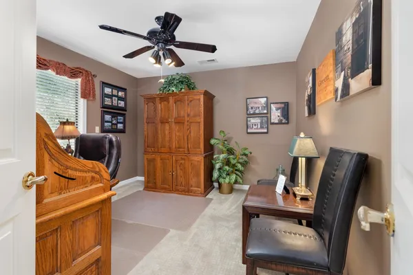 a bedroom with a bed and ceiling fan