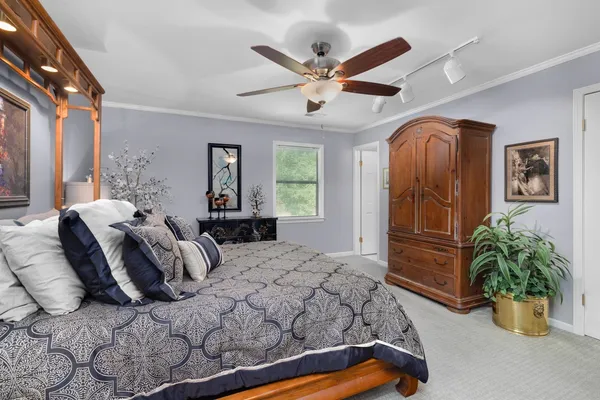 a bedroom with a bed and a large window