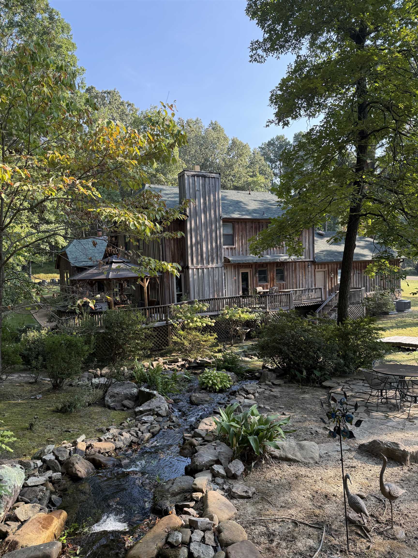 120 Blueberry Road Eads, TN 38028 - Photo 4 of 35 5 Different Patio Seating Areas, deck that wraps around the back of the home with a gazebo, serenity and peace from the sound of the waterfall that meanders through the property. Irrigation system as well. Extensive landscaping.