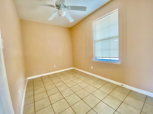 6100 Felix Avenue, Unit B Austin, TX 78741 - Photo 8 of 9 Spare room featuring a ceiling fan and tile patterned floors