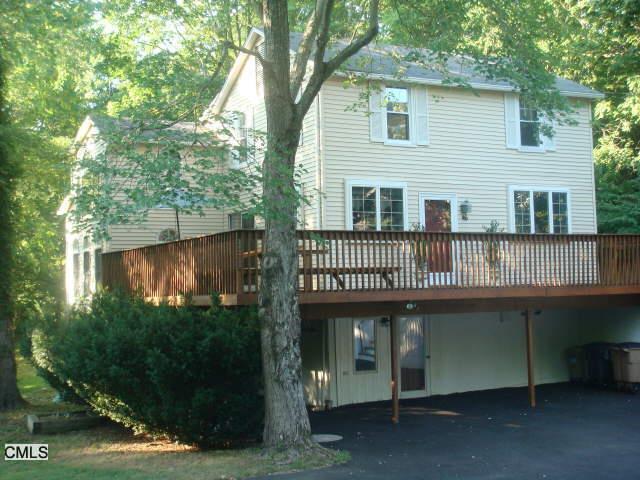 46 Wire Mill Road Stamford, CT 06903 - Photo 1 of 1 a front view of a house with a yard and potted plants