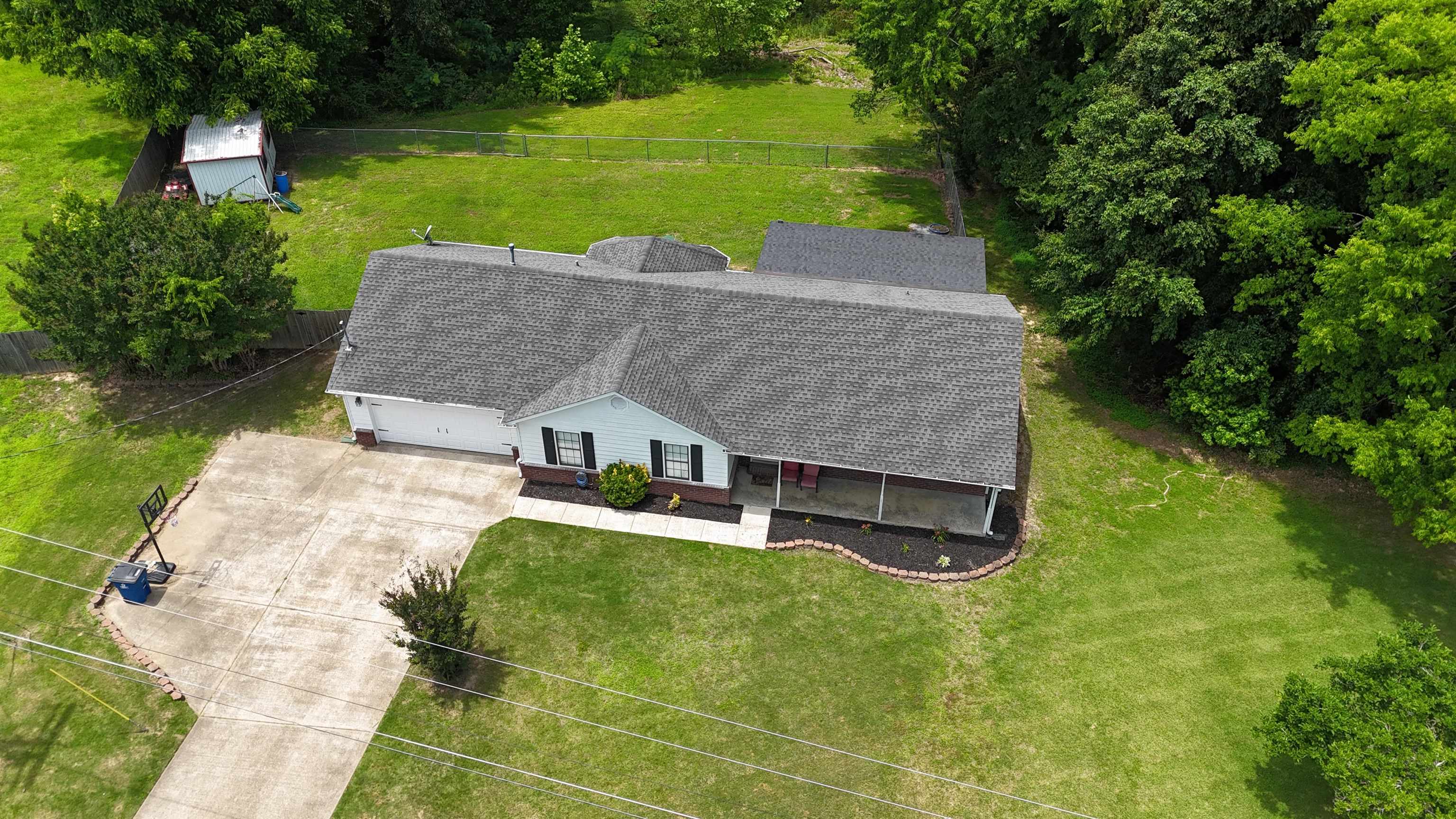 185 Mignon Road Atoka, TN 38004 - Photo 4 of 34 Ranch-style residence featuring a gray shingle roof, attached two-car garage, and a covered front porch