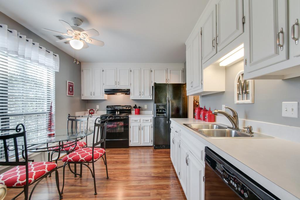 951 General George Patton Road Nashville, TN 37221 - Photo 13 of 25 a kitchen with refrigerator cabinets and wooden floor