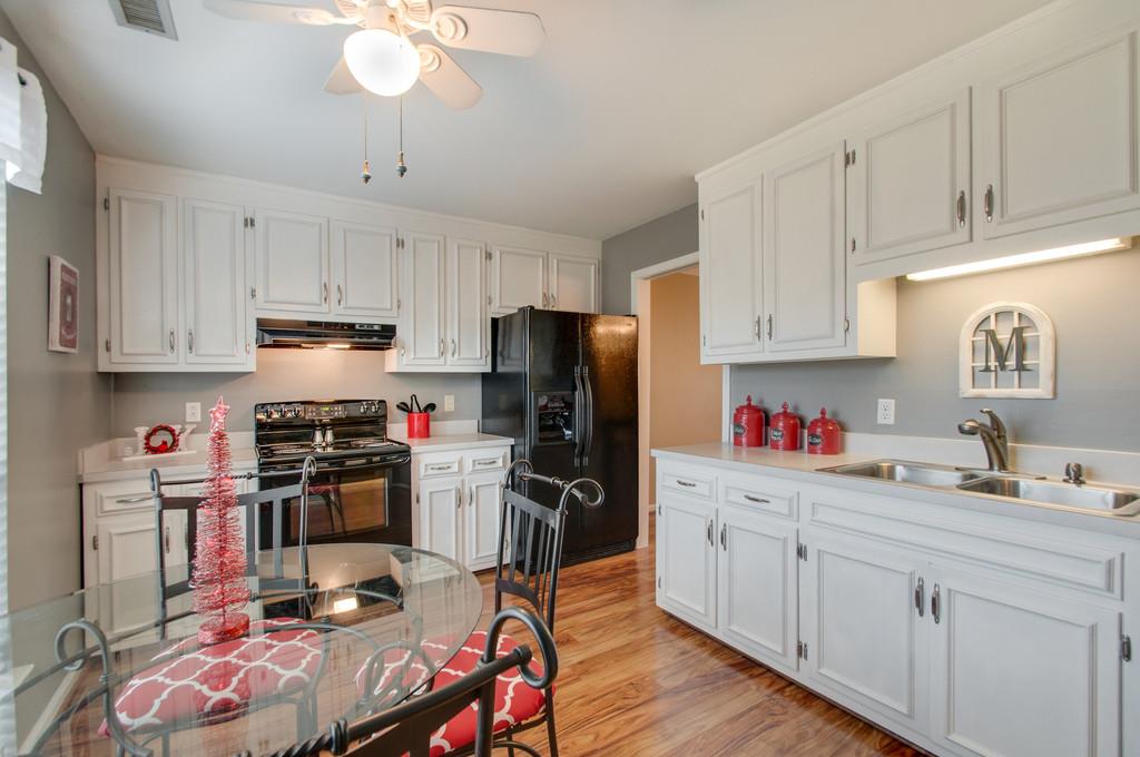951 General George Patton Road Nashville, TN 37221 - Photo 14 of 25 a kitchen with kitchen island granite countertop a sink cabinets and stainless steel appliances