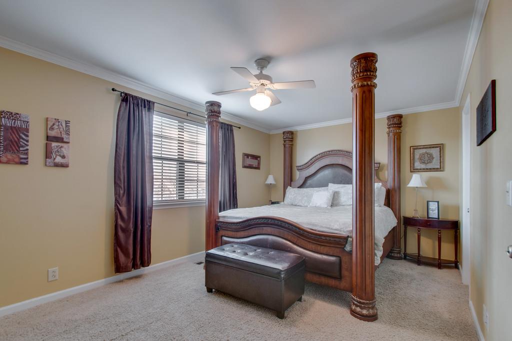 951 General George Patton Road Nashville, TN 37221 - Photo 17 of 25 a bedroom with a bed and a chandelier