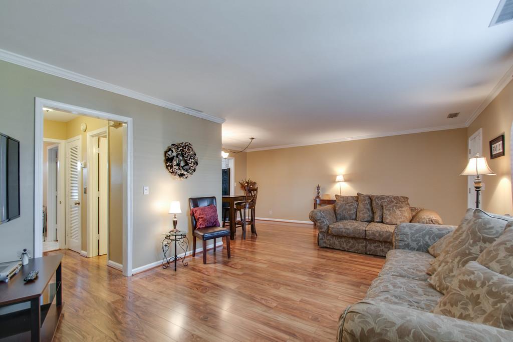 951 General George Patton Road Nashville, TN 37221 - Photo 8 of 25 a living room with furniture and a dining table with wooden floor