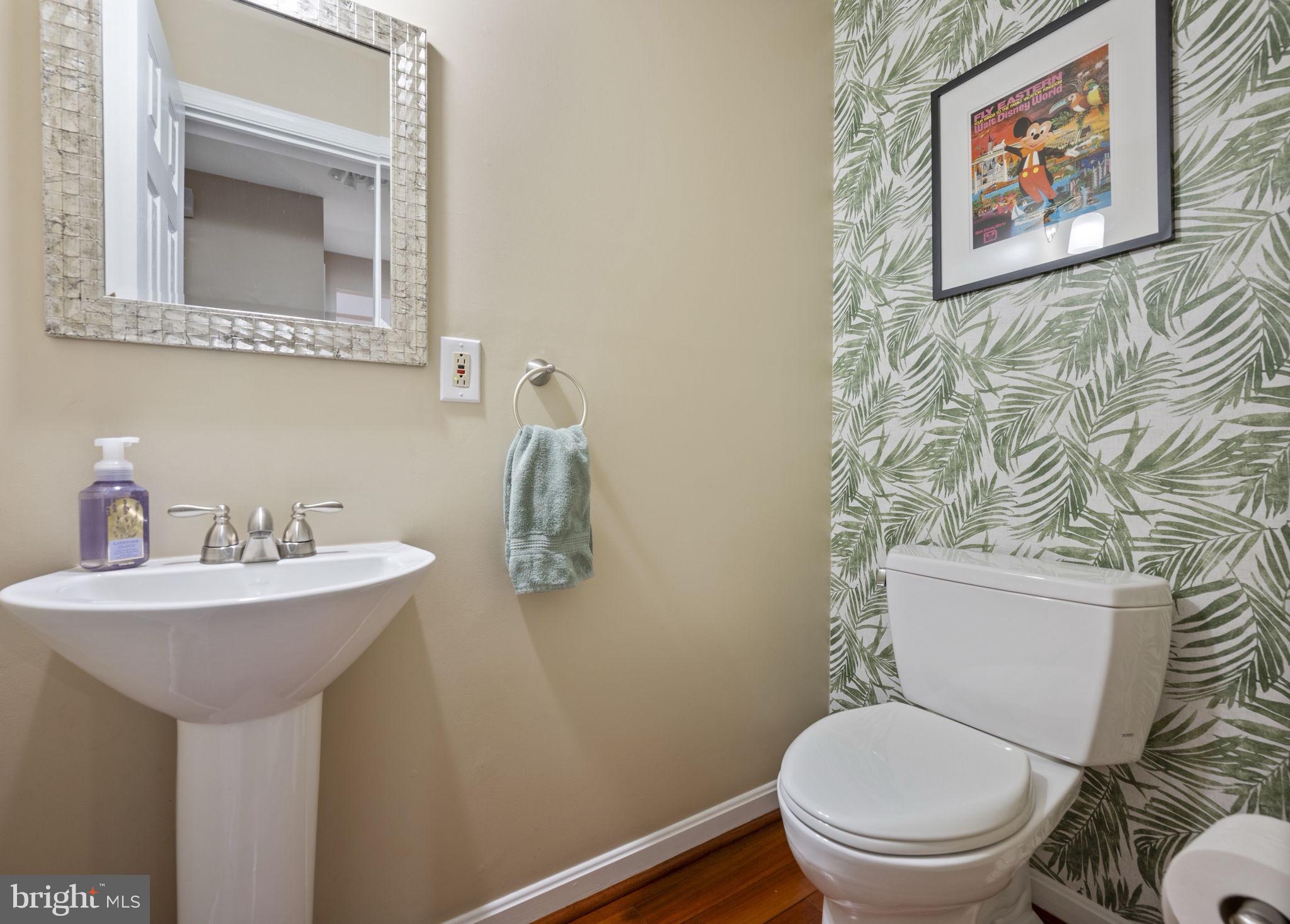 4310 Necker Avenue Nottingham, MD 21236 - Photo 16 of 56 a bathroom with a toilet sink and mirror