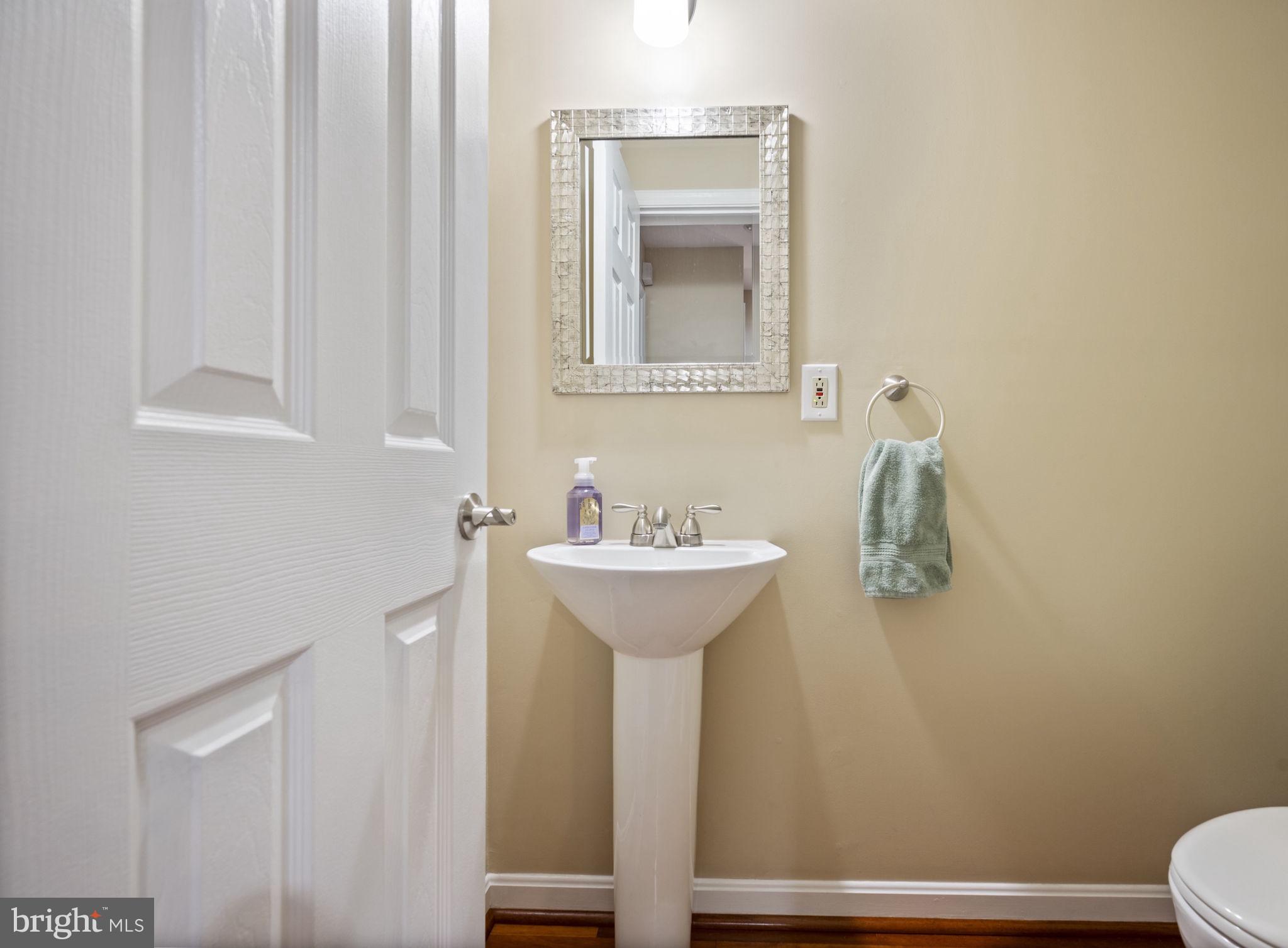 4310 Necker Avenue Nottingham, MD 21236 - Photo 17 of 56 a bathroom with a sink a toilet and mirror