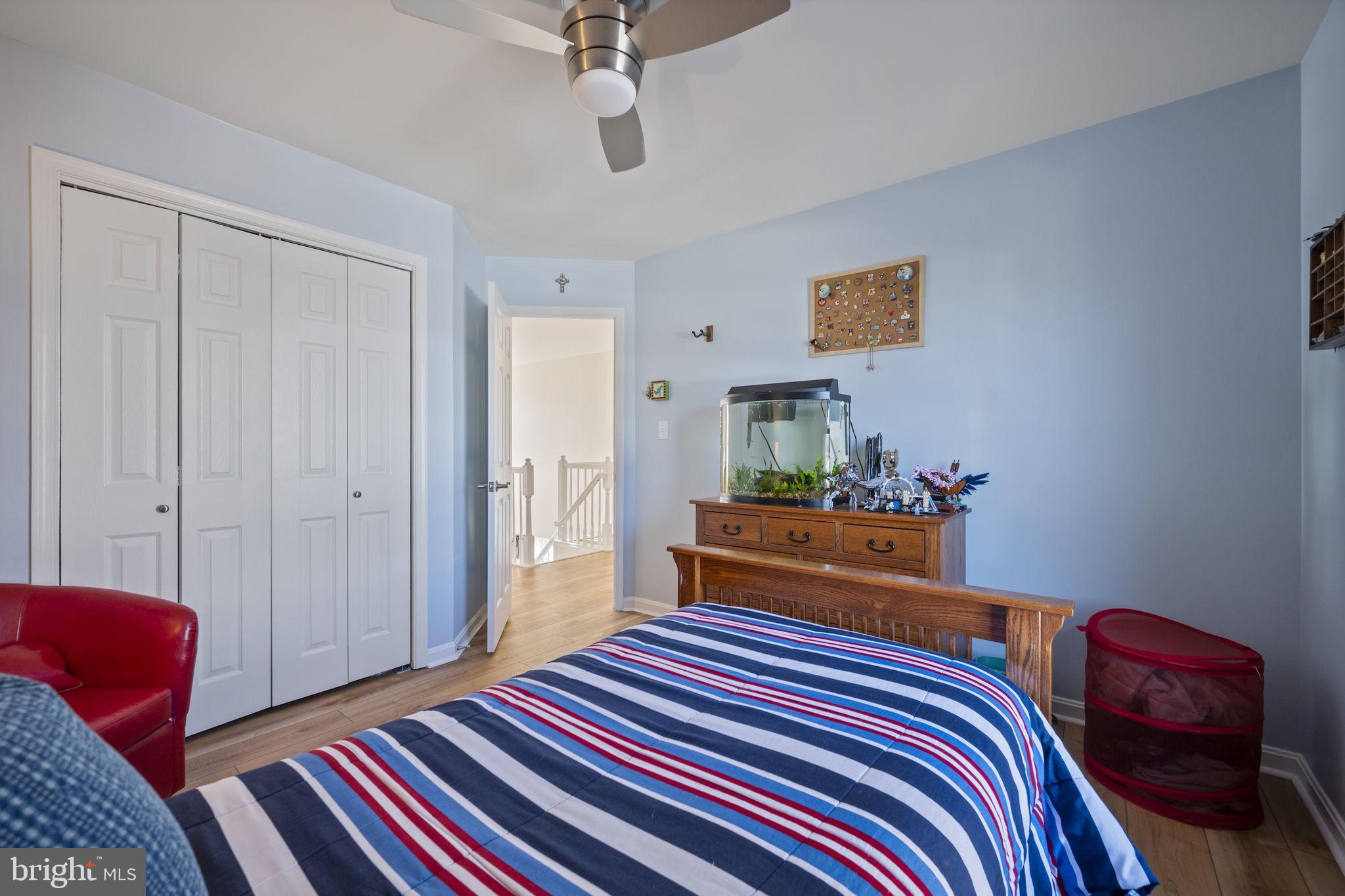 4310 Necker Avenue Nottingham, MD 21236 - Photo 30 of 56 a bedroom with a bed and a lamp on dresser