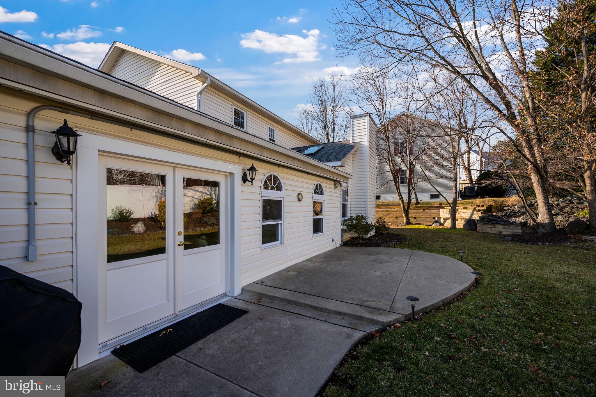 4310 Necker Avenue Nottingham, MD 21236 - Photo 49 of 56 a view of a white house with a large windows and a yard