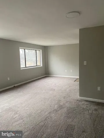 a kitchen with stainless steel appliances granite countertop a refrigerator a stove a sink and white cabinets