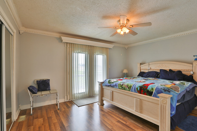 32005 South Klemme Road Beecher, IL 60401 - Photo 8 of 17 a bedroom with a bed and a chandelier
