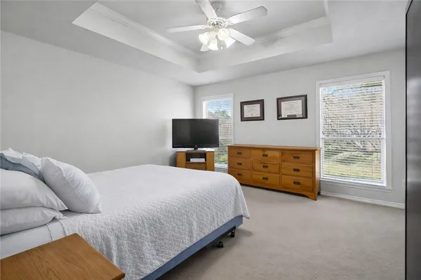 a bedroom with a bed and a tv