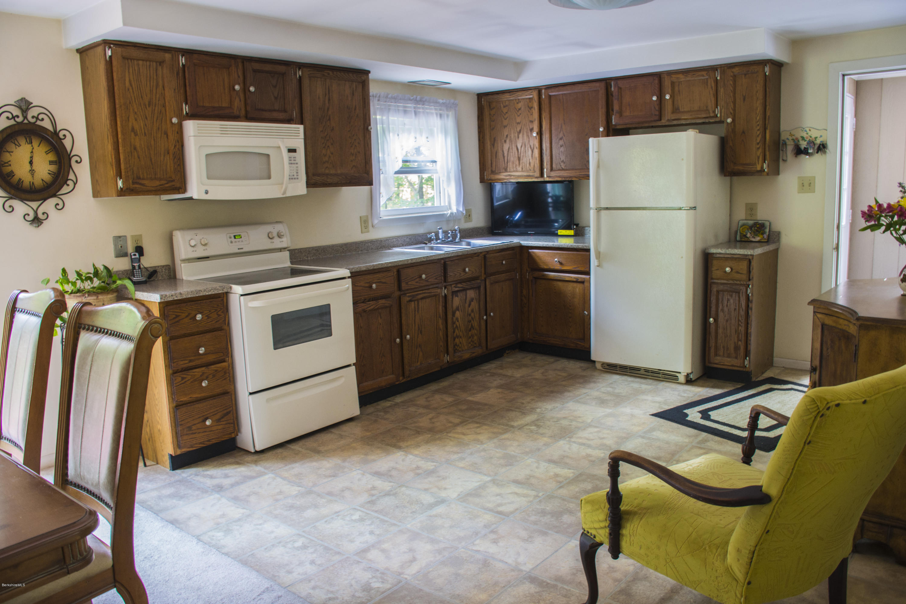 654 Clayton Road Sheffield, MA 01222 - Photo 5 of 20 a kitchen with a refrigerator sink and white cabinets