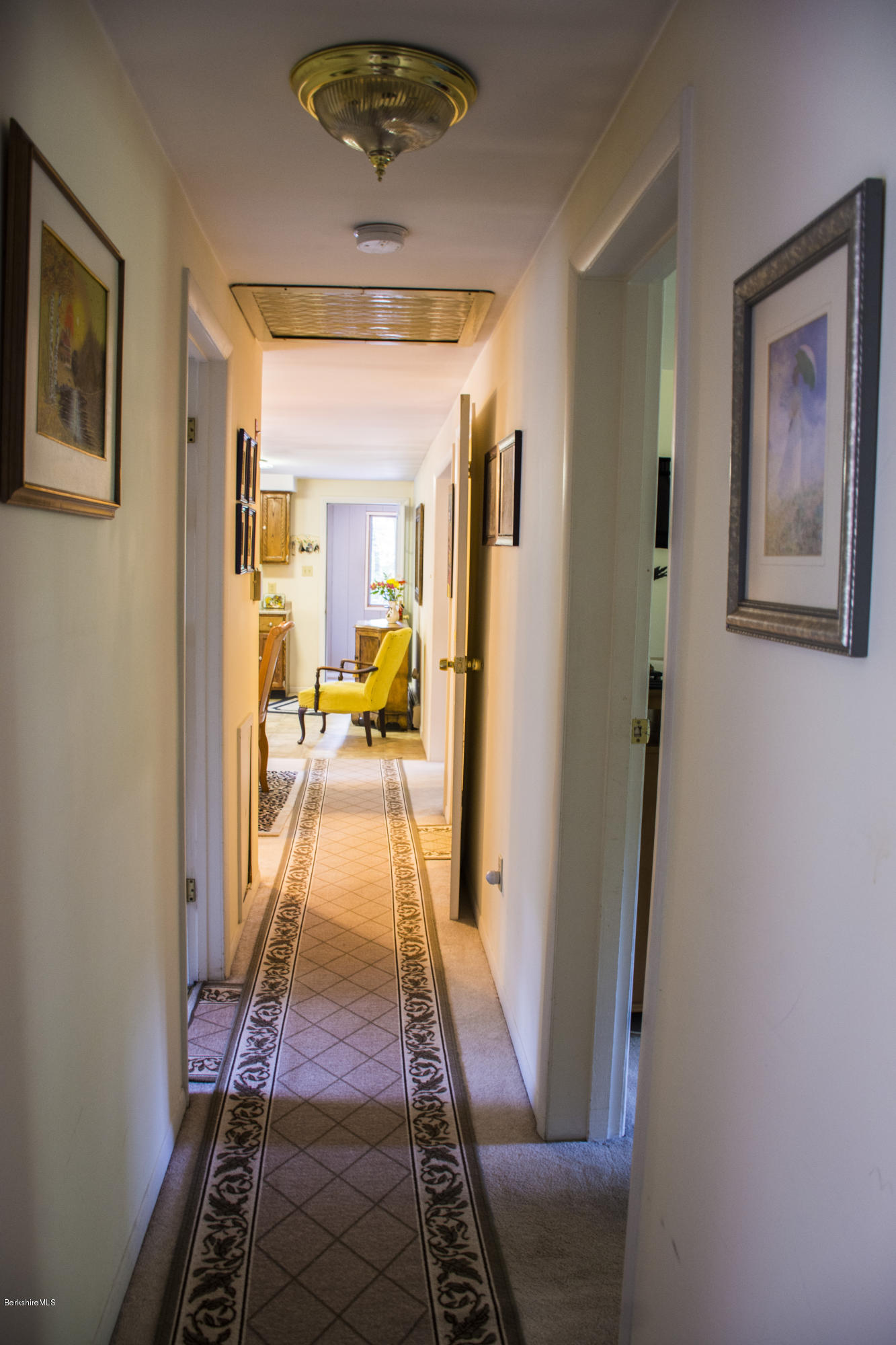 654 Clayton Road Sheffield, MA 01222 - Photo 7 of 20 a hallway with mirror and a dining table